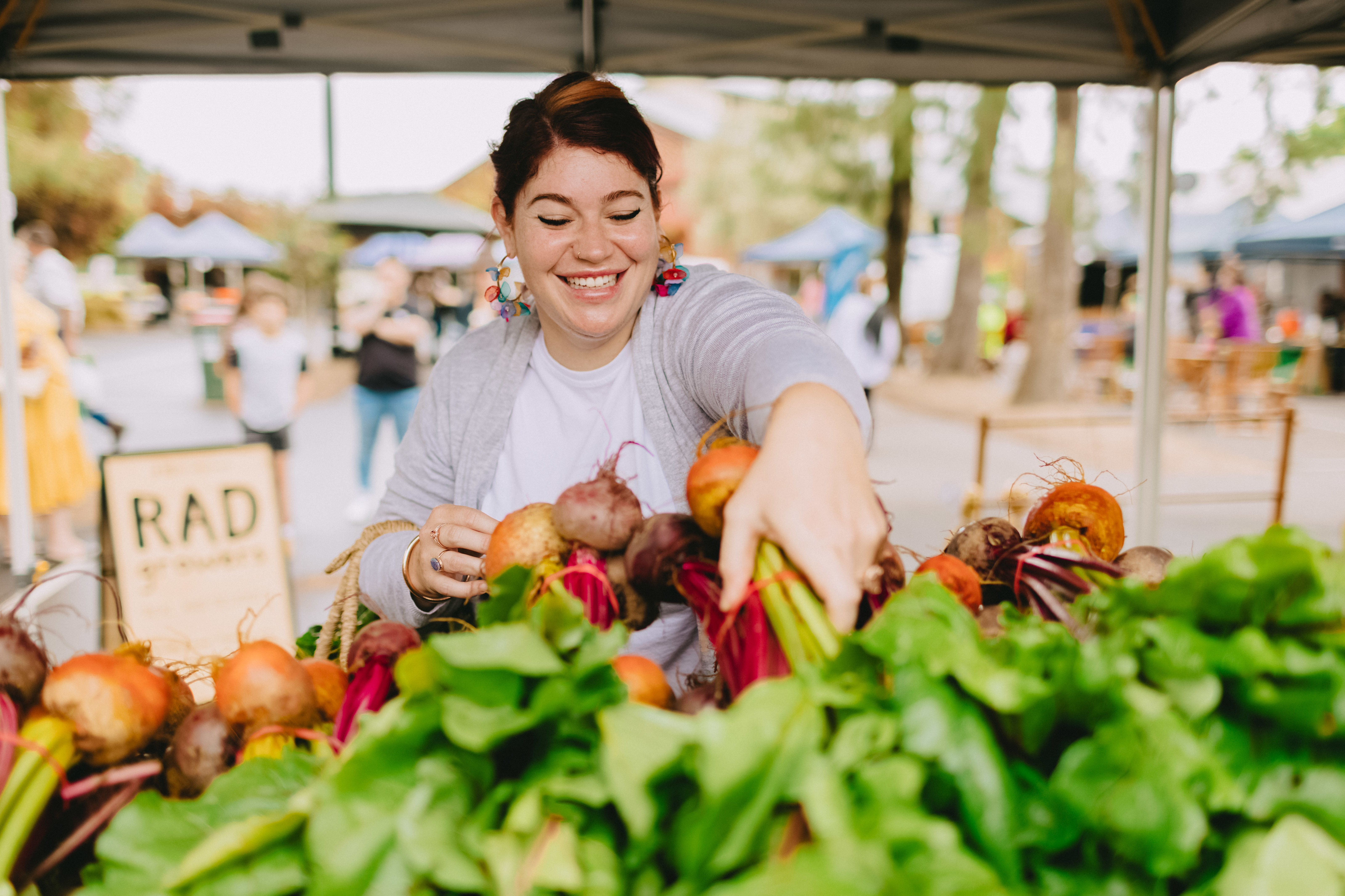 Woman buying rhubarb at markets